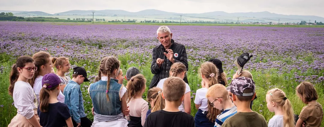 Kids paying attention to a farmer while he talks about his farm